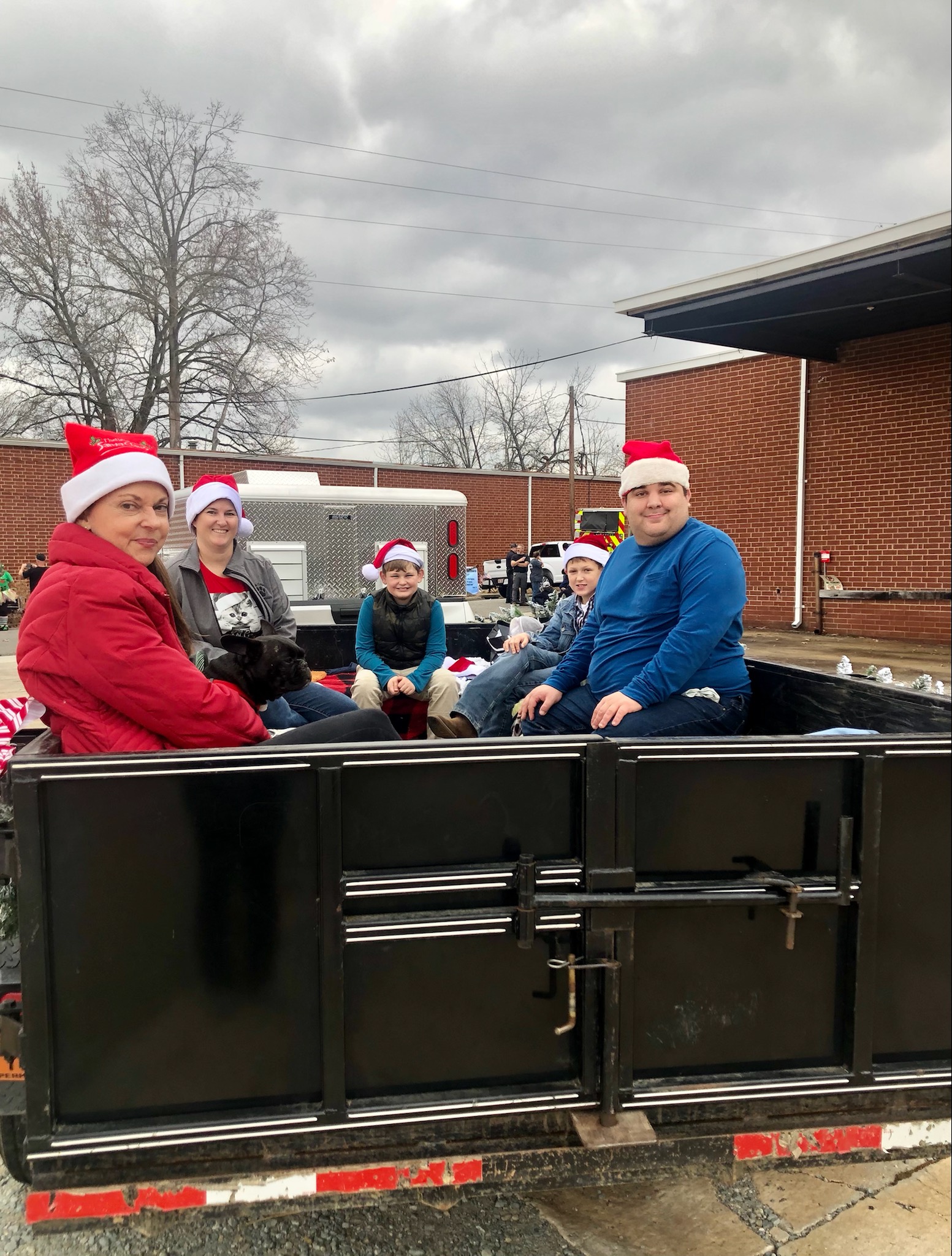 staff and volunteers wearing santa hats in christmas parade